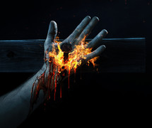 nail through the hand of Christ and flames 