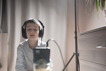 a child in a recording studio with headphones 