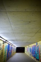 graffiti covered tunnel at night 