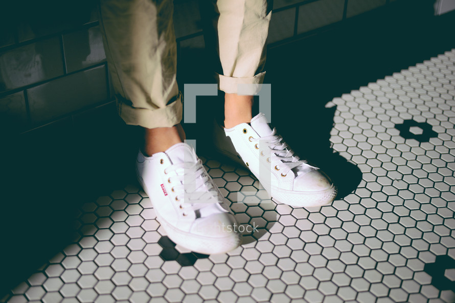 sneakers standing on tile floor 