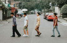 teen boys crossing a street 
