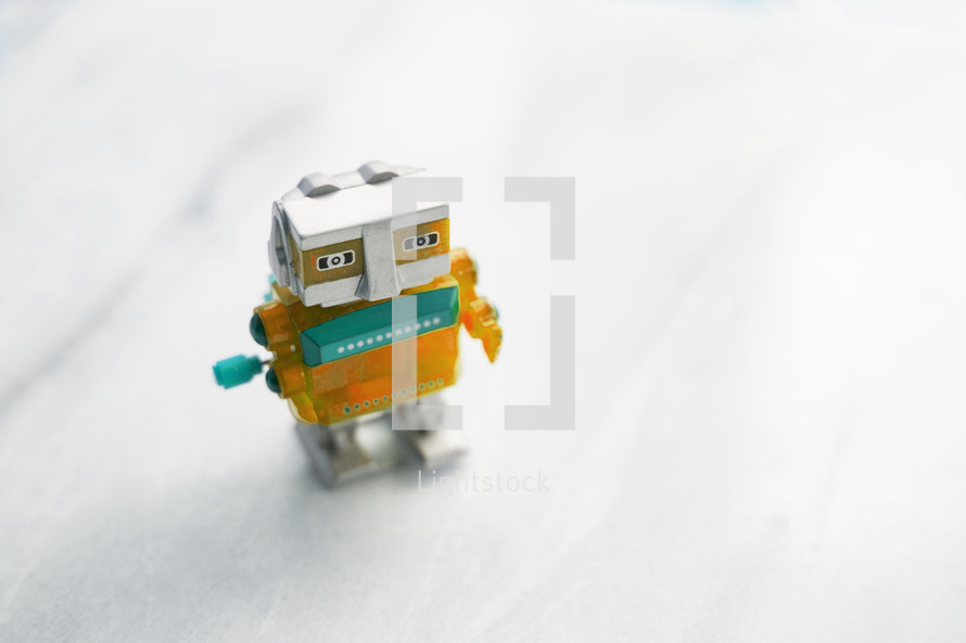 A small, plastic, wind-up robot.
