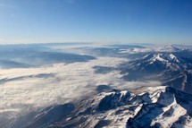 aerial view over snow capped mountains 