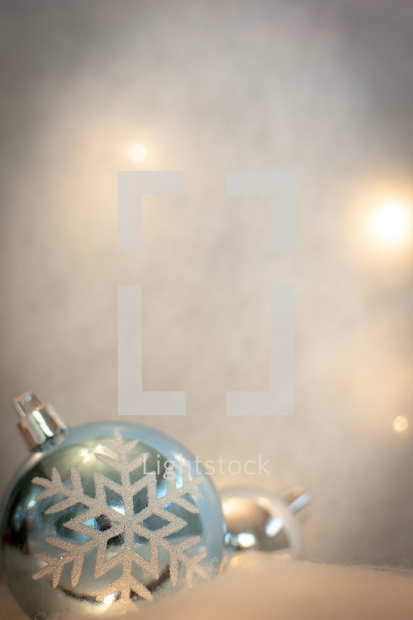 Silver snowflake baubles on white backgrounds