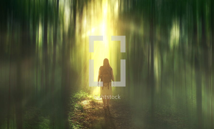 a woman with a backpack standing in a glowing forest 