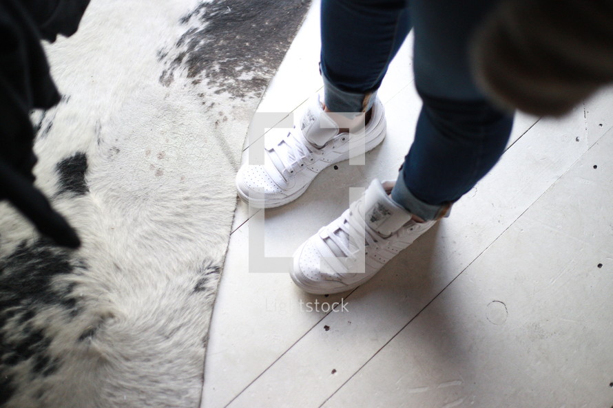 feet in white sneakers 