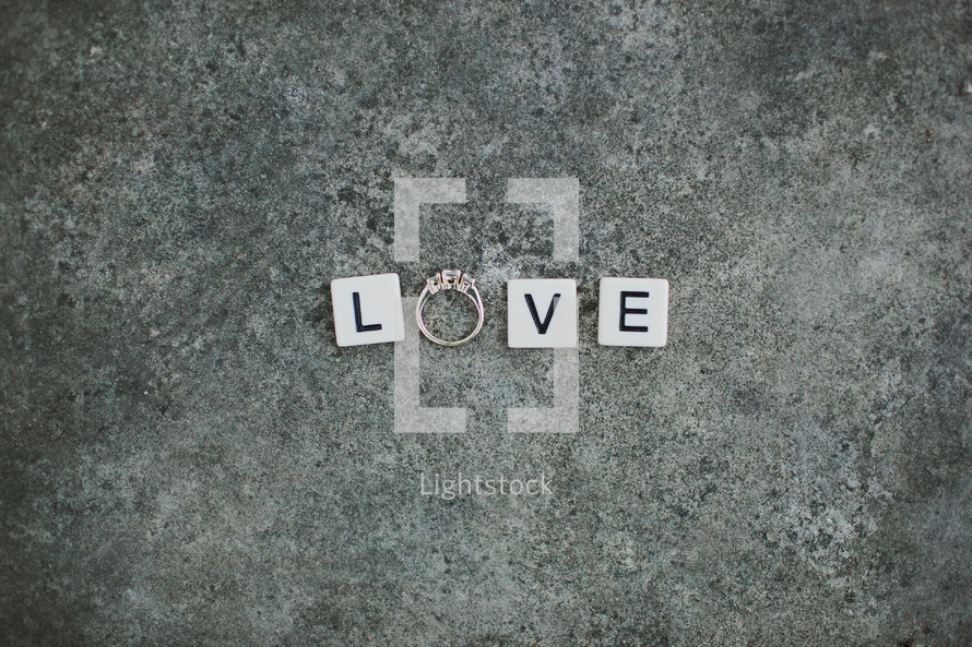 word love - scrabble pieces and an engagement ring