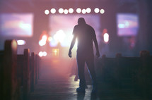 man walks down to the front of the church during a worship service