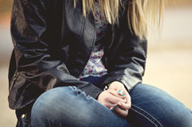 teen girl with praying hands in her lap 