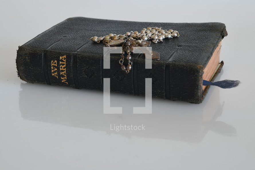 rosary on an old worn Bible 