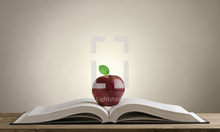 apple on the pages of a book