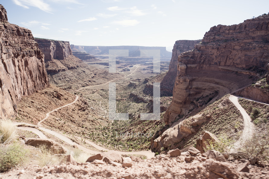 winding road through desert mountain cliffs 