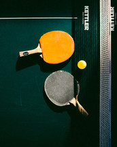paddles on a ping pong table 