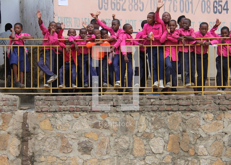 African school children standing on a balcony 