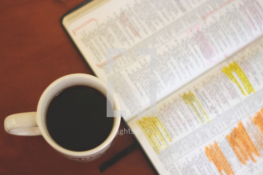 coffee mug and highlighted open Bible