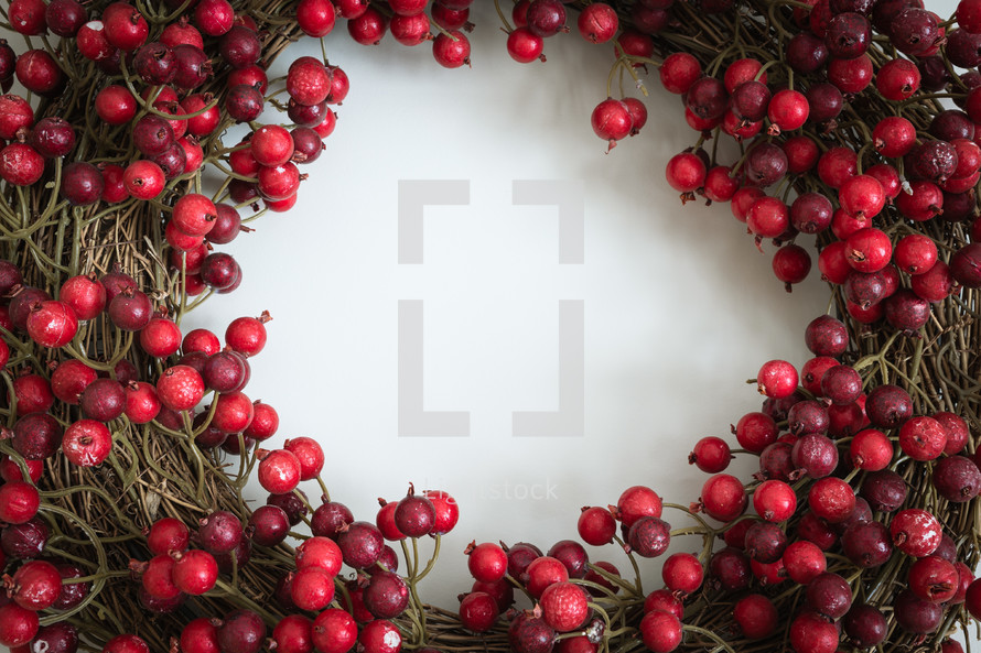 Red berry wreath on a white background