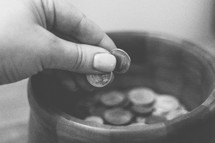 placing coins in a jar 