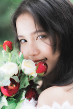 girl holding red and white roses 
