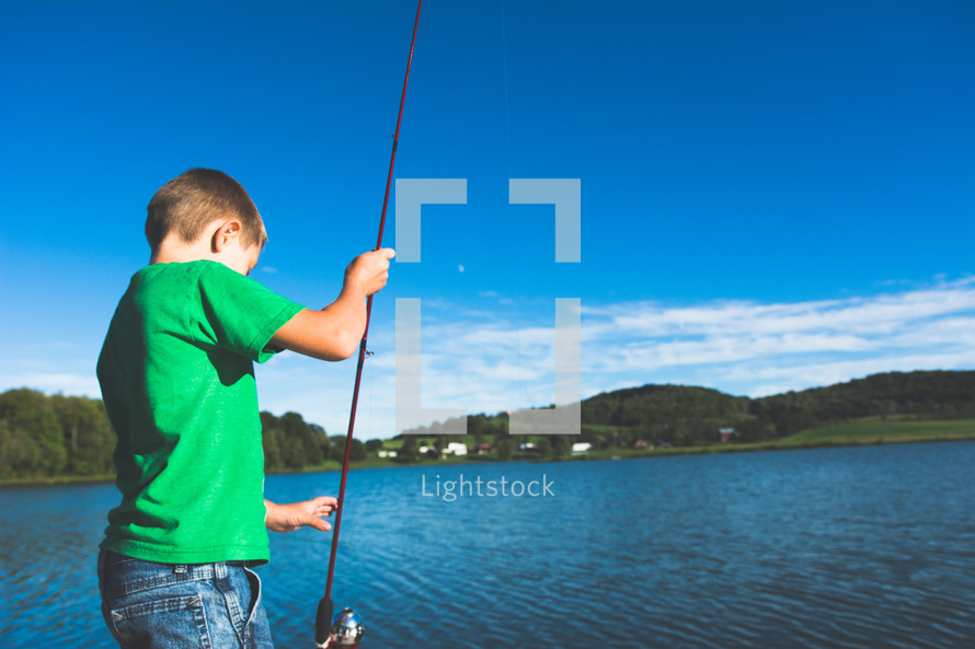 a boy child with a fishing pole 