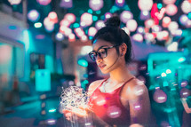 a teen girl holding a glowing ball of lights 
