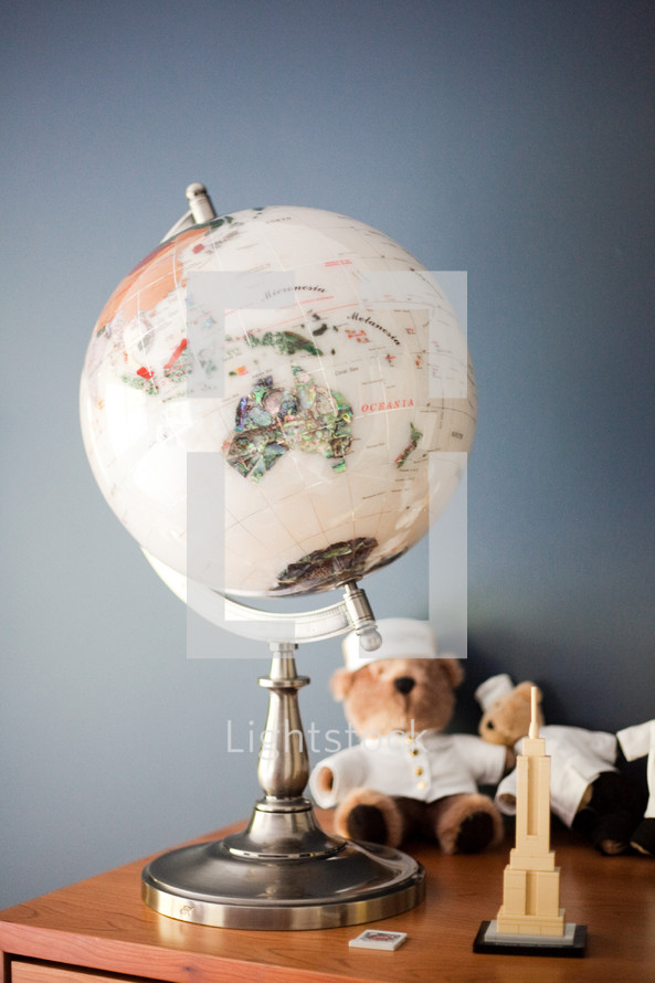 globe on a desk and teddy bears 