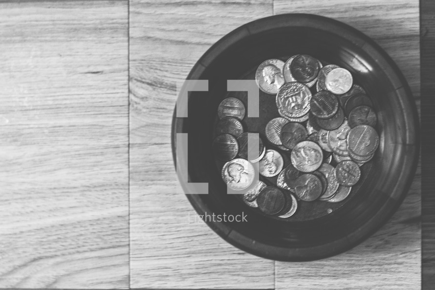 Coins in a wooden bowl.