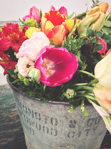 A bucket of  spring flowers.