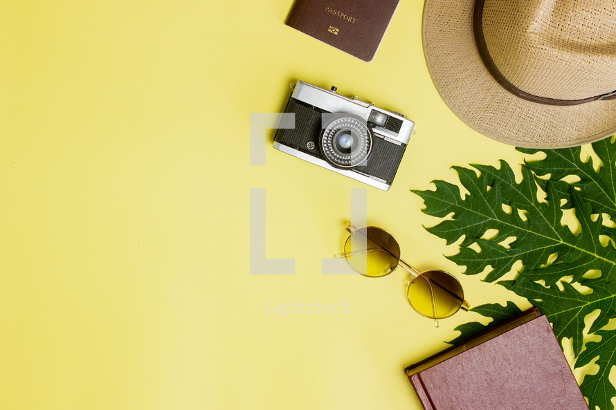 travel items on a yellow background 