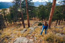 a woman hiking up a mountainside 