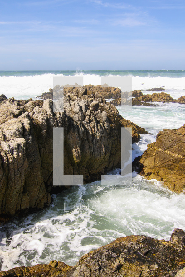 ocean water washing onto a rocky shore 