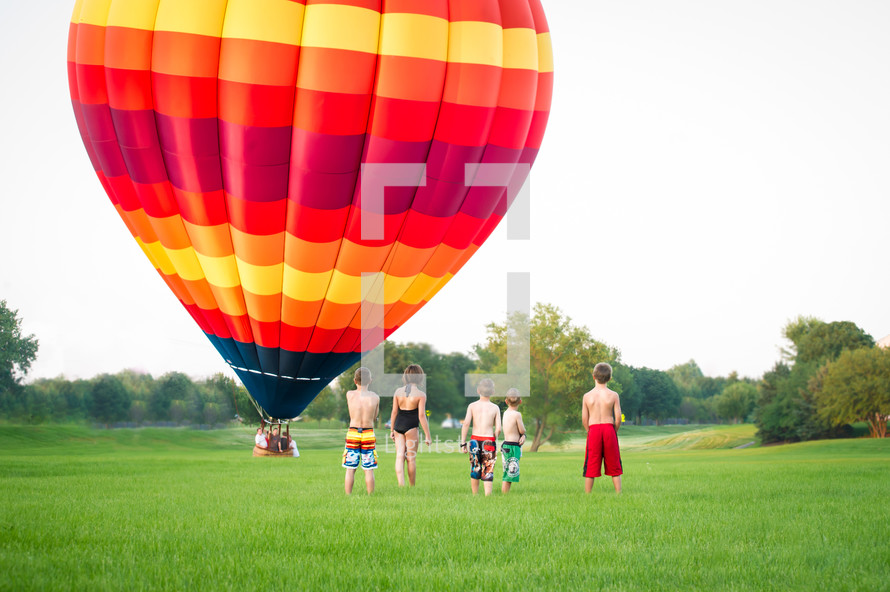 hot air balloon and children watching