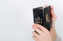 Child's hands holding the Bible.