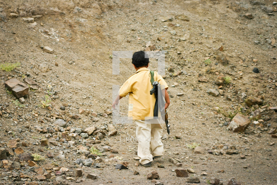 a child carrying a gun for his family as they return from recreational shooting