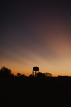 water tower silhouette at sunset 
