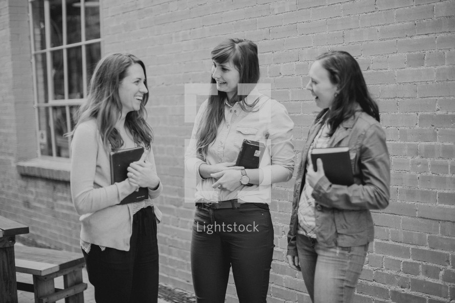 young women in a women's group holding Bibles 