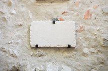 Blank tablet with text space on a white stone building