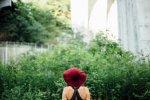 woman in a red hat with her back to the camera 