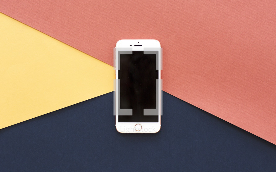 iPhone on a red, yellow, and navy background 