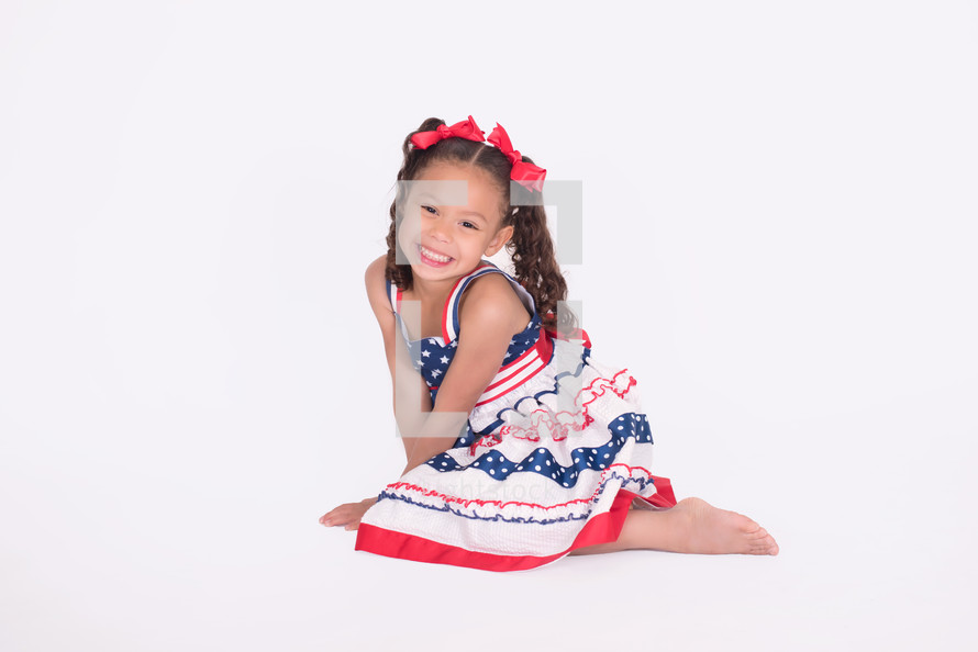 a portrait of a girl child in a patriotic dress 