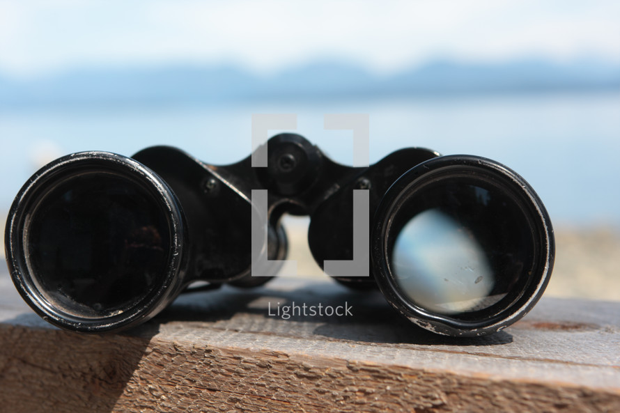 binoculars on a railing