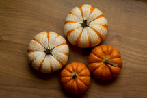 mini pumpkins on a wood background 