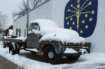 A vintage pickup truck in the snow