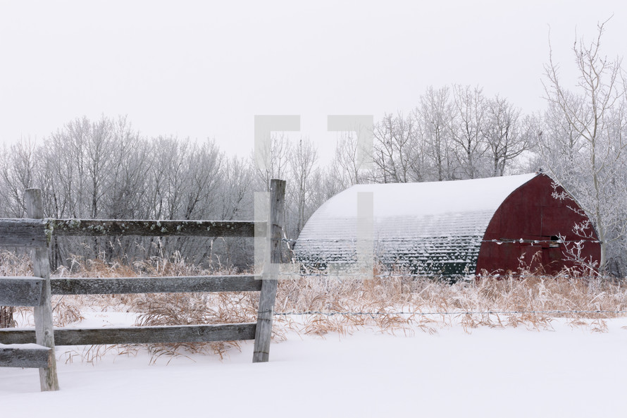 red barn on a foggy winter day 