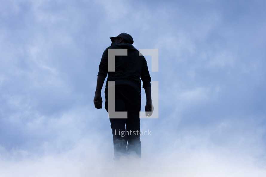 man silhouette in the clouds