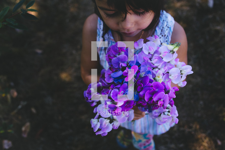 girl child holding picked flowers 