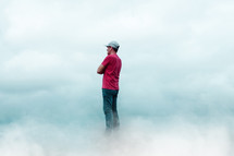 man praying among the clouds, feelings and emotions