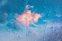 drops on the window and blue sky background