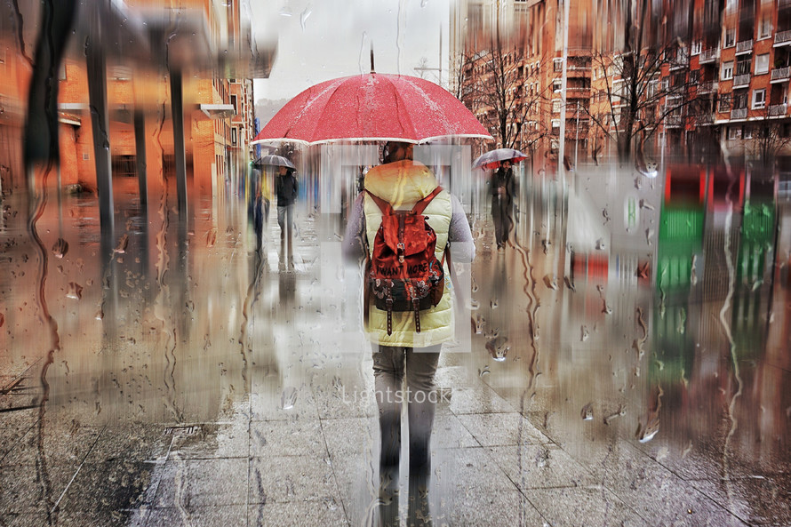 pedestrian on the street with an umbrella in rainy days in winter season