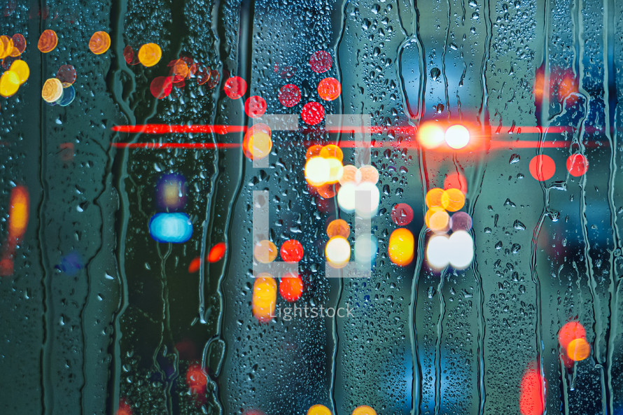 drops on the window and street lights background 