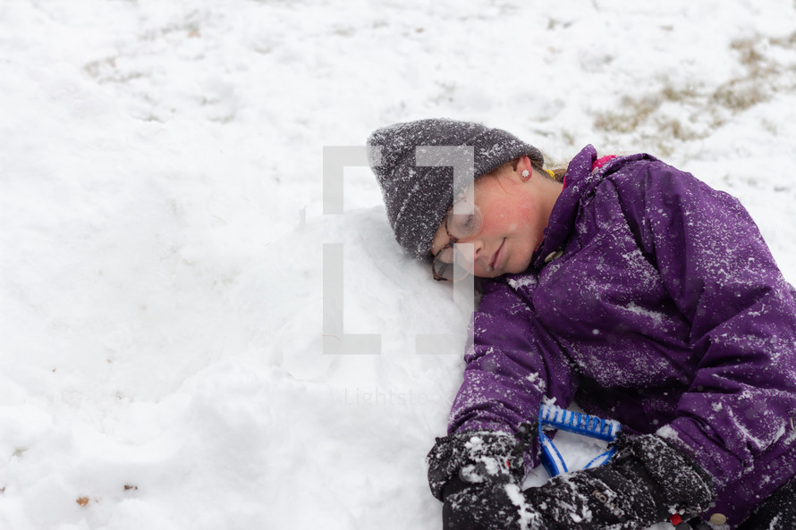 a girl resting in snow 